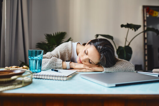 Tired freelancer sleeping on desk at home office