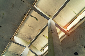 Obraz premium industrial warehouse or commercial area in an architectural background with bare cement pillars supporting a ceiling before construction