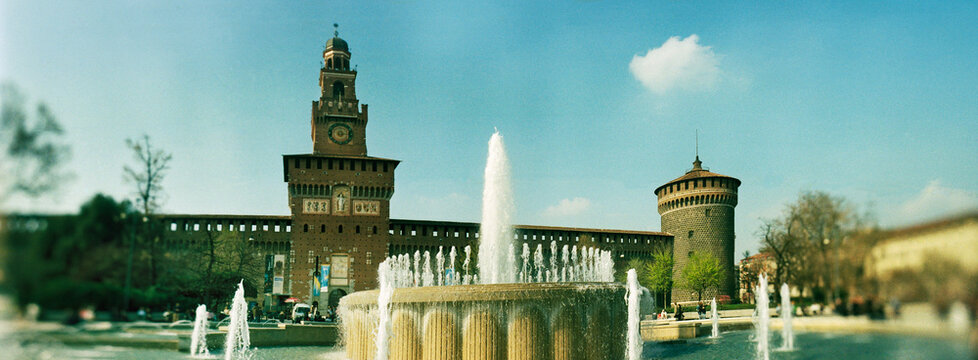 Panoramic view of Fontana di Piazza Castello, a large, scenic fountain located in a public square directly in front of the Sforza Castle (Castello Sforzesco) Milan, Italy, Europe