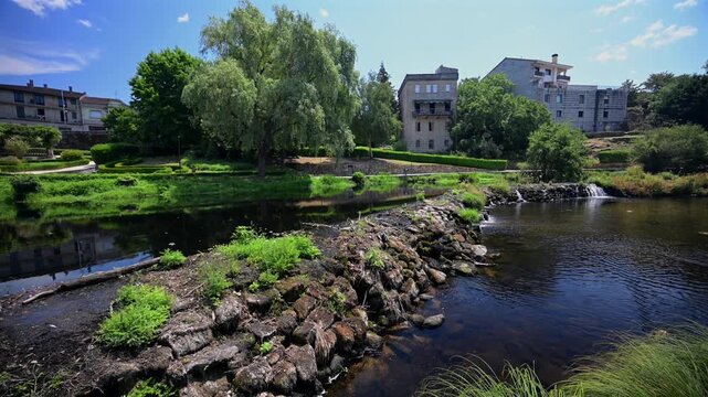 Cascading Waterfall Weir along the Arnoia River and Green Parklands in the Village of Allariz Galicia