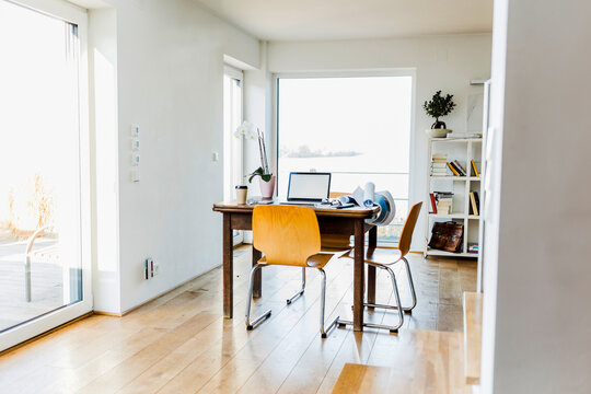 Laptop on wooden desk in an apartment