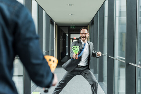 Businessman playing with colleague on the corridor