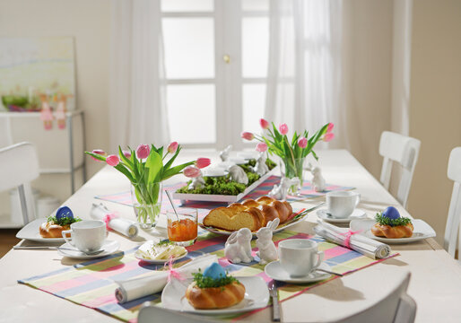 Decorated dining table set for Easter breakfast in a bright studio