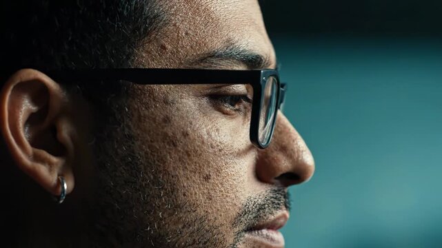 Closeup profile portrait of a young man with glasses