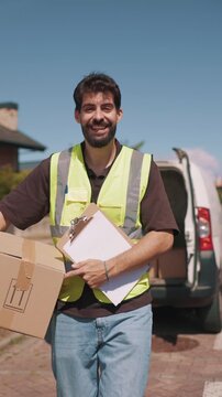 vertical Delivery driver carrying a package from the van