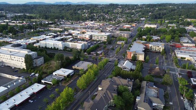 Low rise professional buildings anchor historic business zones near downtown Kent, King County. Dense mixed use development signals ongoing neighborhood transformation occurring throughout WA