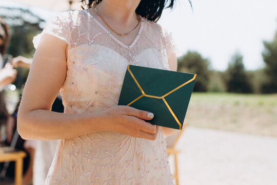Woman holding green envelope for celebration event