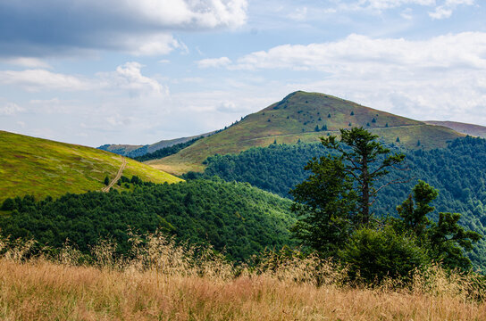 Beautiful panoramic view of green mountain ridge and hills under cloudy summer sky. Beautiful panoramic view of Borzhava mountain ridge under cloudy summer sky in Carpathians Ukraine