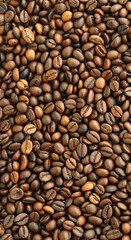 Fototapeta premium Detailed view on brown roasted coffee beans in big pile on table close up
