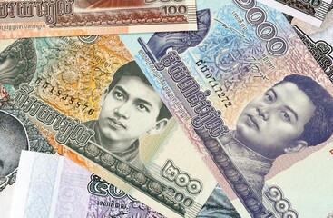 Cambodian riel money bills in pile on table. Cambodia KHR currency cash close up © Viktor