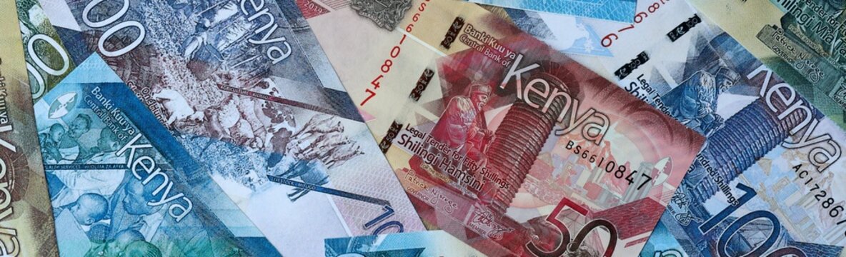 Kenyan shilling money bills in pile on table. Kenya KES currency cash close up