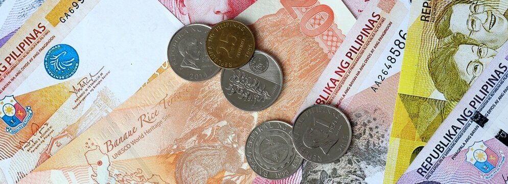 Philippine peso money banknotes and coins on table. Philippines cash bills of PHP currency