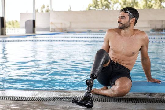 Adaptive swimmer with prosthetic leg at poolside