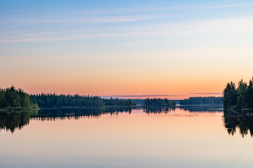 Obraz premium Calm Lake Landscape in Finland at Sunset
