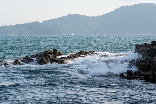 Rocky headlands and rocks are struck by powerful waves that crash with energy. Angra dos Reis &ndash; Rio de Janeiro, Brazil.