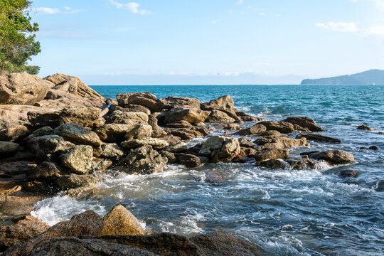 Rocky headlands and rocks are struck by powerful waves that crash with energy. Angra dos Reis &ndash; Rio de Janeiro, Brazil.
