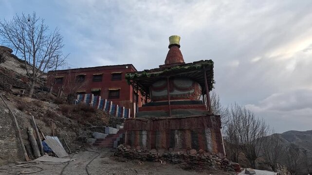 Sacred chorten prayer flags stone buildings Ghiling Upper Mustang valley landscape
