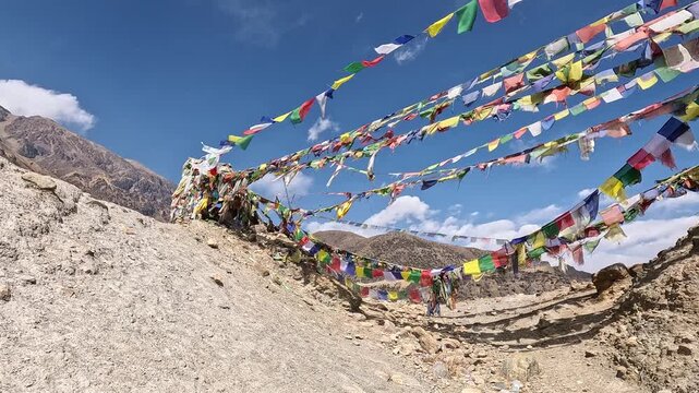 Colorful prayer flags fluttering mountain pass Dajori La peaks sky Upper Mustang