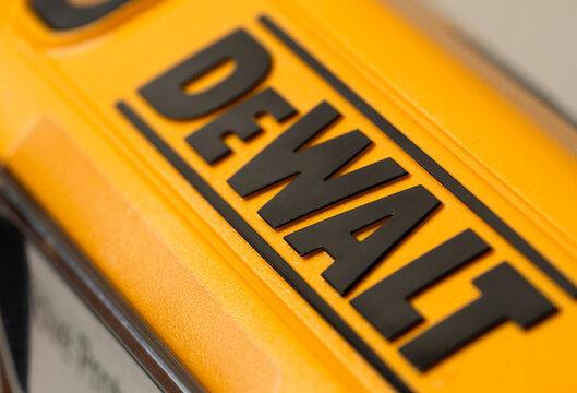 Kharkiv, Ukraine, July 13 2026: Illustrative editorial of DeWalt brand logo in black lettering on a yellow plastic tool housing, showing texture and molded surface detail. Selective focus.