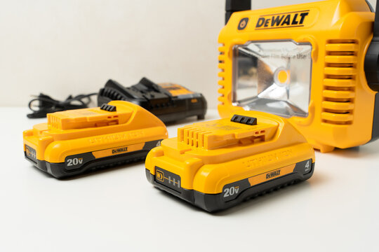 Kharkiv, Ukraine, July 12 2026: Illustrative Editorial of DeWalt DCL077 LED Work Light with 20V Batteries and Charger on White Background.