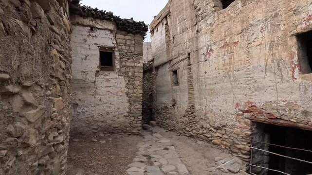 Narrow stone-walled lane, ancient mud plaster walls, traditional architecture, Chele Nepal