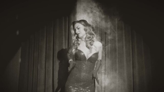 black and white color film retro lady sexy happy woman fashion model posing dancing, long dress gloves. girl beauty face old style glamour actress stands on stage room. hair 20s new year night club.