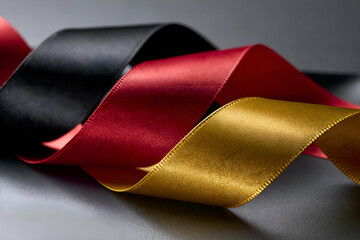 Folded black, red and gold ribbons, German Unity Day concept