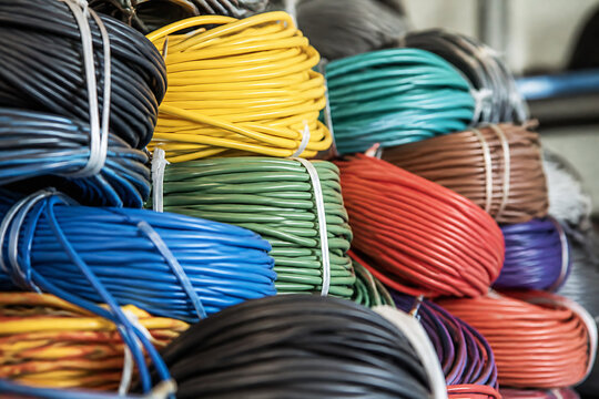 A large pile of colorful electrical wires and cables is displayed in a storage or wholesale setting.