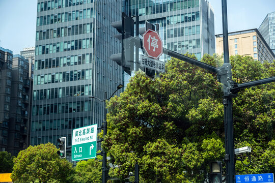 Traffic lights and N S Elevated Road signs at Shanghai, China intersection under blue sky