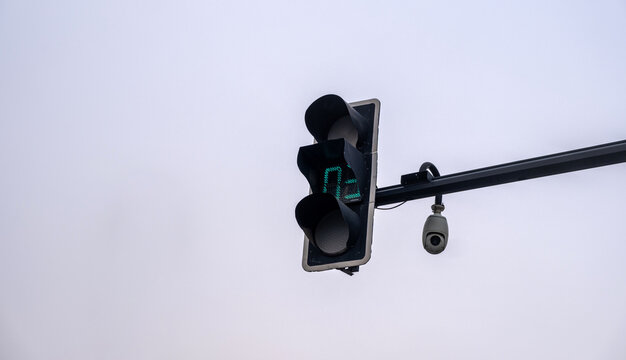 Traffic signal with countdown timer and camera on pole above intersection, China