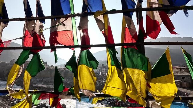 Close-up wind-blown prayer flags, vibrant colors, Buddhist prayers, Kali Gandaki Nepal