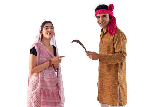 Portrait of happy couple with sickle in hand