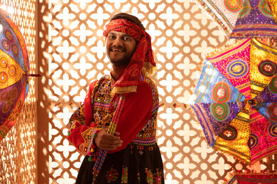 Portrait of Gujrati man with dandiya sticks