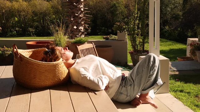young woman relaxing , leaning on table, sunbathing