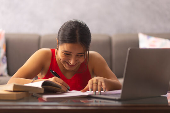 Portrait of a teenage girl having online class at home