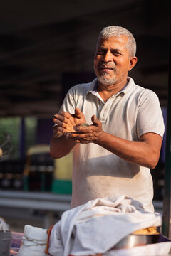 Male vendor making dough at his roadside food stall
