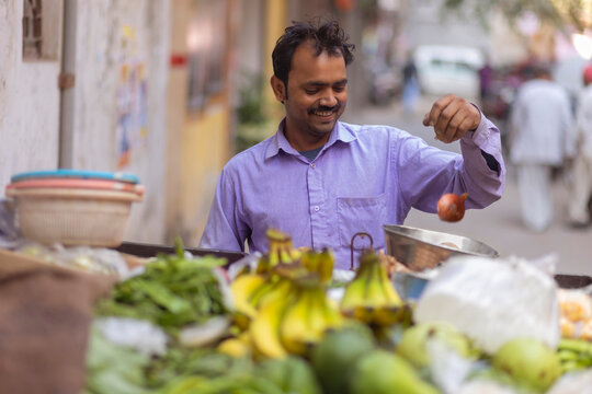 Male vendor selling vegetables at his roadside stall