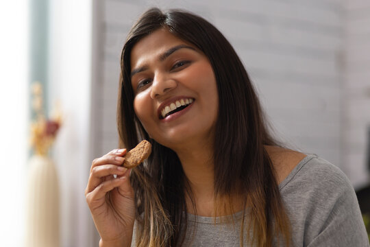 Close-up portrait of woman eating cookies