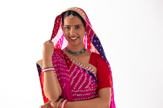 Portrait of Rajasthani woman in sari standing against white background