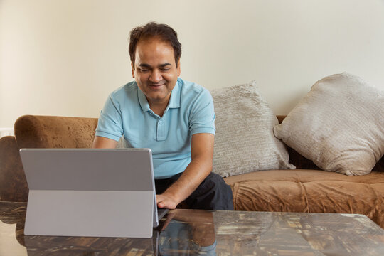 Man using laptop in living room