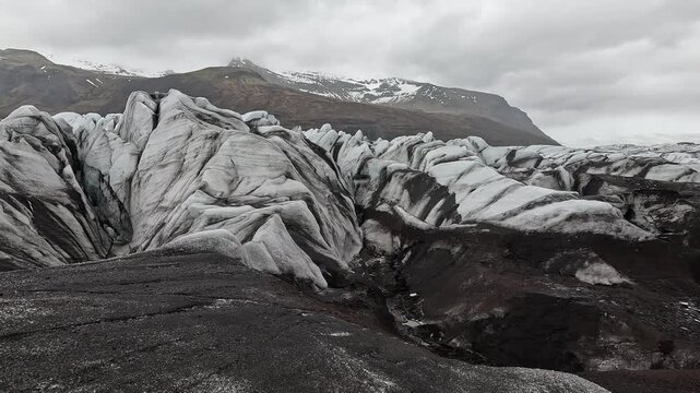 Svinafellsjokull on-glacier wide serac field with blue ice peaks, Oraefjokull mountains behind, Iceland