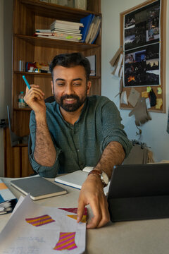 A male designer working on designs in the studio