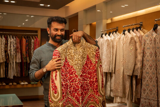 Buyer trying Indian wear in a clothing store 