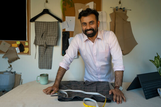 A menswear designer posing in his studio 
