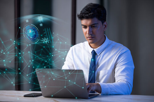 Businessman working on laptop computer with icons on virtual screen