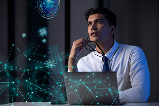 Businessman working on laptop computer with icons on virtual screen