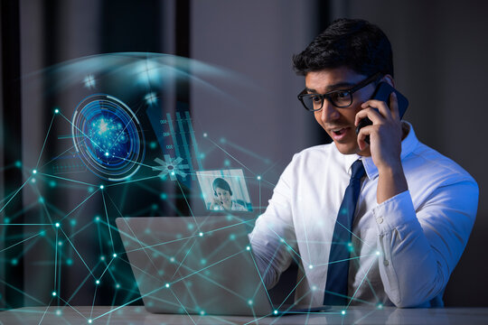 Businessman working on laptop computer with icons on virtual screen