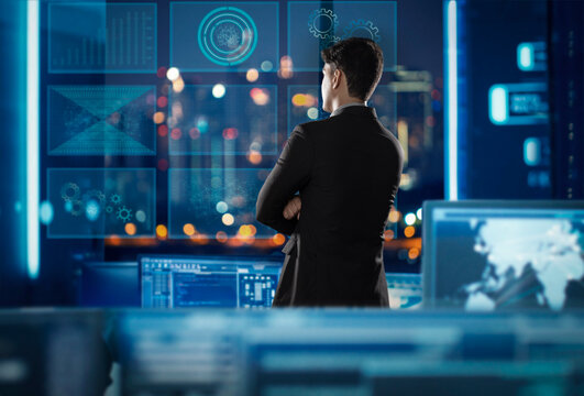 Digitally enhanced shot of a businessman  superimposed over multiple screens of virtual reality projections screens