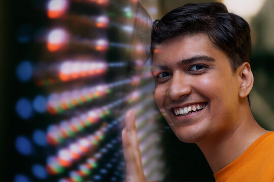 Happy young  man with futuristic digital screen