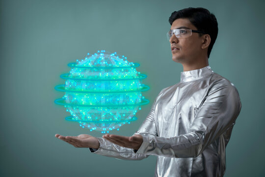 A man wearing silver,futuristic  clothes holding digital globe ,future technology concept